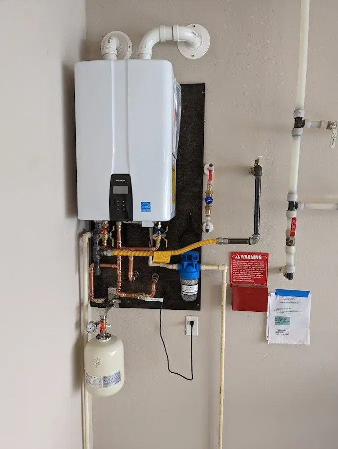 Professional plumber installing copper piping in a Lynnfield home